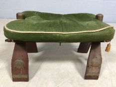 Camel stool with green upholstered seat on brass studded frame