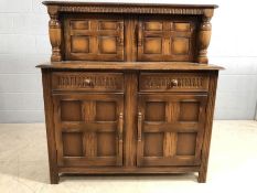 Dark wood buffet or sideboard with linen fold design and two cupboards over