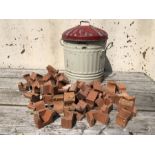 Collection of terracotta pot stands and a rustic bin