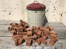 Collection of terracotta pot stands and a rustic bin