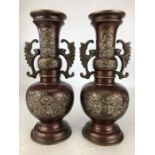 Pair of Chinese bronzed and brass vases with engraved chinese characters and applied brass