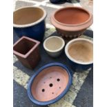 Six assorted stone garden pots
