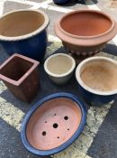 Six assorted stone garden pots