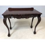 Modern carved occasional table on ball and claw feet with upstand, approx 94cm x 46cm x 76cm tall
