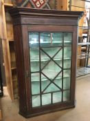 Wall hanging corner cupboard with glazed door