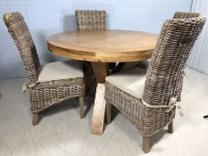 Light wood contemporary circular dining room table on three solid wooden legs, approx 120cm in