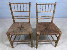 Pair of rush-seated chairs with bamboo style slatted backs and stretchers