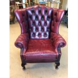 Red leather fireside wingback armchair (A/F)