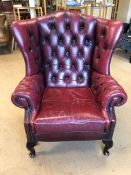 Red leather fireside wingback armchair (A/F)