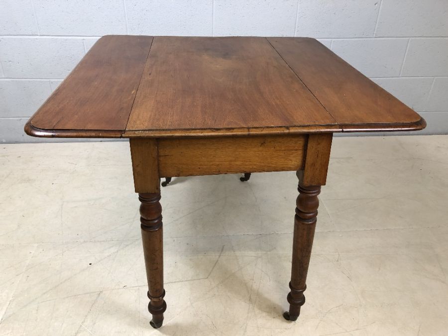 Mahogany drop leaf table on turned legs with original castors and hidden drawer, approx 90cm x - Image 7 of 10