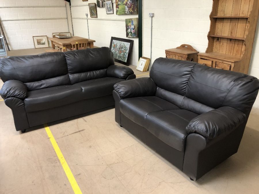 Two brown imitation leather sofas, the larger approx 186cm in length x 85cm deep