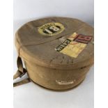 Vintage canvas hat box with wicker lining and travel labels for the British India Line (First