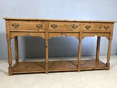 Antique pine buffet / sideboard with three drawers, brass handles and shelf to base approx 186cm x