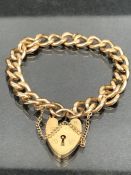9ct Gold curb link (every link stamped 9ct 375) bracelet with 9ct gold heart shaped lock and