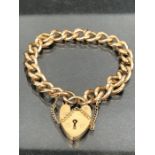 9ct Gold curb link (every link stamped 9ct 375) bracelet with 9ct gold heart shaped lock and