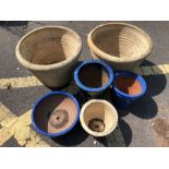 Six assorted stone garden pots