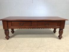 Modern coffee table on turned legs with two drawers and metal handles, approx 130cm x 47cm x 45cm