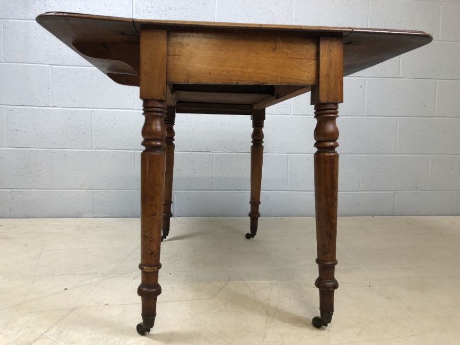 Mahogany drop leaf table on turned legs with original castors and hidden drawer, approx 90cm x - Image 8 of 10