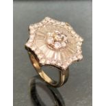 Art Deco Style Starburst Diamond ring with seven diamonds set to the centre in a diasy cluster,