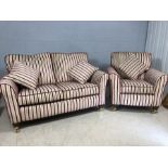 Contemporary two seater sofa with matching armchair and cushions on brass castors