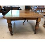 Victorian oak extending dining room table on original castors with two extra leaves and with