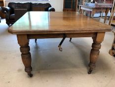 Victorian oak extending dining room table on original castors with two extra leaves and with