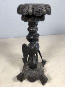 Heavily carved Eastern origin plant stand / candleholder with carved detailing of a bird fighting