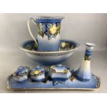 Dressing table set comprising jug, bowl, tray, pots, vase etc with colourful fruit design (A/F)