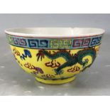 Chinese rice bowl depicting dragons and flaming pearls on a yellow ground A/F