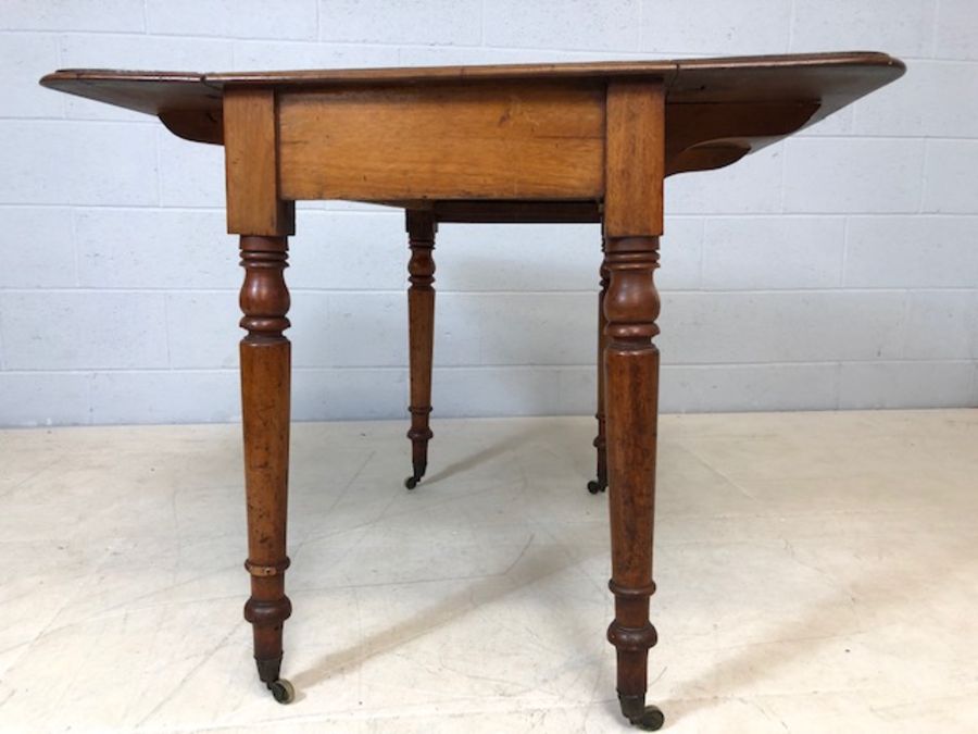 Mahogany drop leaf table on turned legs with original castors and hidden drawer, approx 90cm x - Image 3 of 10