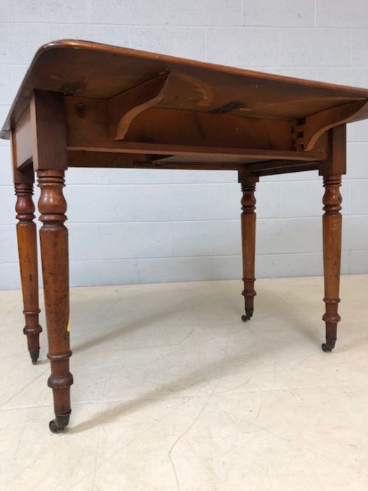 Mahogany drop leaf table on turned legs with original castors and hidden drawer, approx 90cm x - Image 4 of 10