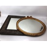 Two bevel edged mirrors with decorative frames, the larger approx 54cm x 44cm