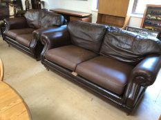 Three seater and two seater brown leather sofas on castors by Thomas Lloyd, the larger approx