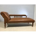 Newly upholstered chaise longue on oak frame with carved and stud detailing and on brass castors