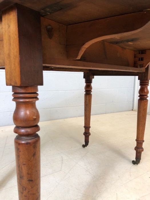 Mahogany drop leaf table on turned legs with original castors and hidden drawer, approx 90cm x - Image 6 of 10