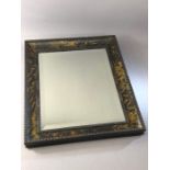 Ercol: tortoiseshell wall mirror, with ebonized ripple mouldings and a bevelled rectangular plate,