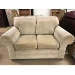 Fawn coloured modern two seater sofa