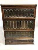 Four section early Globe Wernicke cabinet / book shelves with brass fitments, leaded glass and