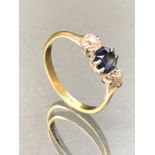 18ct Gold ring with a faceted Sapphire and two Diamonds either side, approx size 'O'