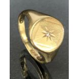 9ct Gold signet ring with starburst design and set with a single diamond to centre approx size 'R' &