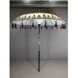 Handmade Thai garden parasol in black and white fabric with woven detailing and black tassels,