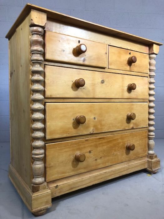 Pine chest of five drawers with turned columns to side on bun feet, approx 57cm x 115cm x 112cm - Image 4 of 5