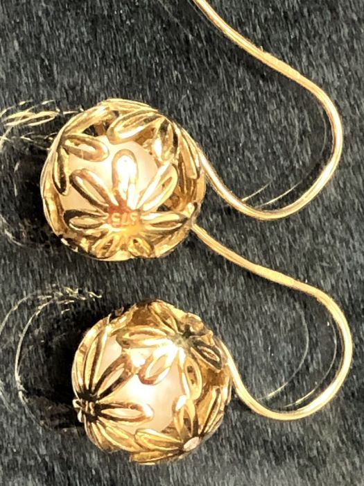 Pair of 9ct Gold earrings of delicate hollow gold balls set with diamonds and each encasing a - Image 2 of 4