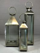 Set of three large contemporary storm lanterns, the largest approx 93cm in height