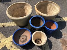 Six assorted stone garden pots