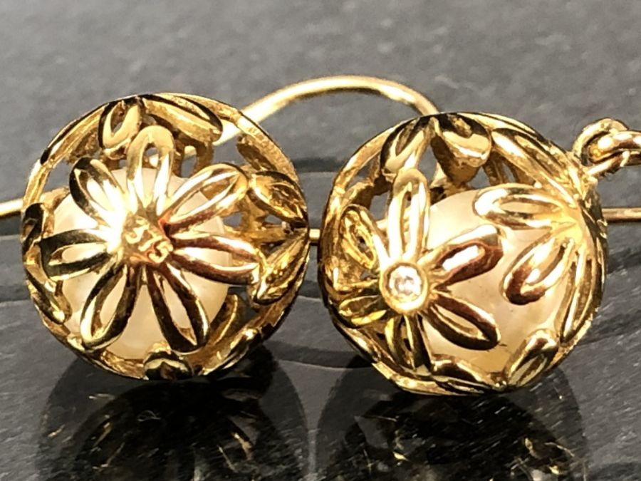 Pair of 9ct Gold earrings of delicate hollow gold balls set with diamonds and each encasing a - Image 4 of 4