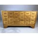 Haberdashery counter with 24 drawers, glass top and carved handles, with Art Deco style feet, approx