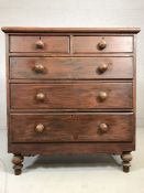 Stained antique pine chest of five drawers with bun handles on turned feet