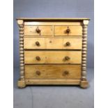Pine chest of five drawers with turned columns to side on bun feet, approx 57cm x 115cm x 112cm