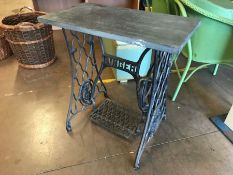 Singer sewing machine iron pedastal base with a slate top to create a vintage table